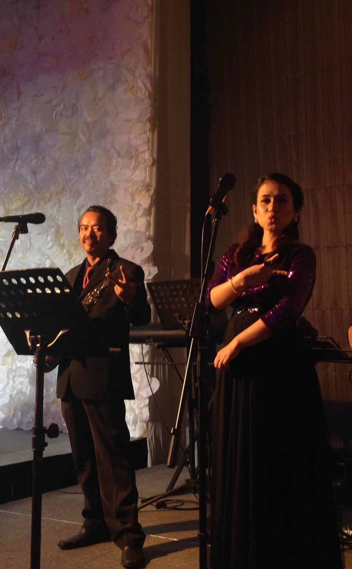 Male and female vocalists singing a duet at a wedding